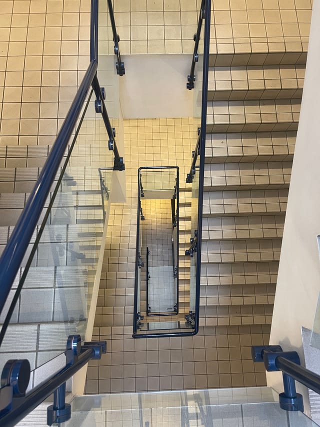 Well-maintained staircase with glass railings, ideal for events and gatherings.