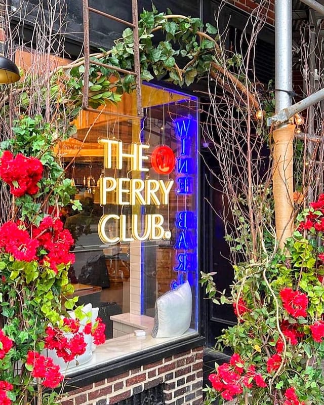 Il Grottino Room entrance at The Perry Club with vibrant floral decor for events.