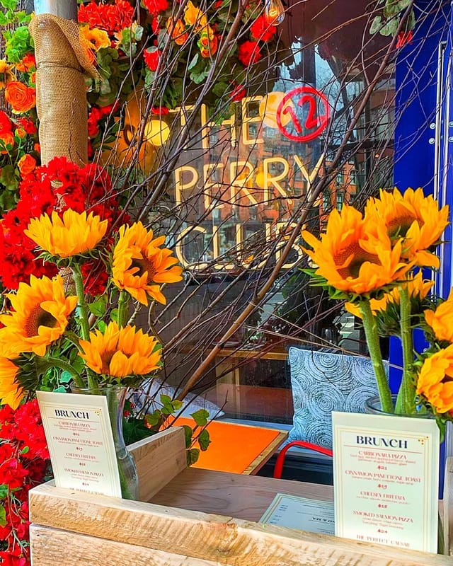 Il Grottino Room at The Perry Club with sunflowers, ideal for events and gatherings.