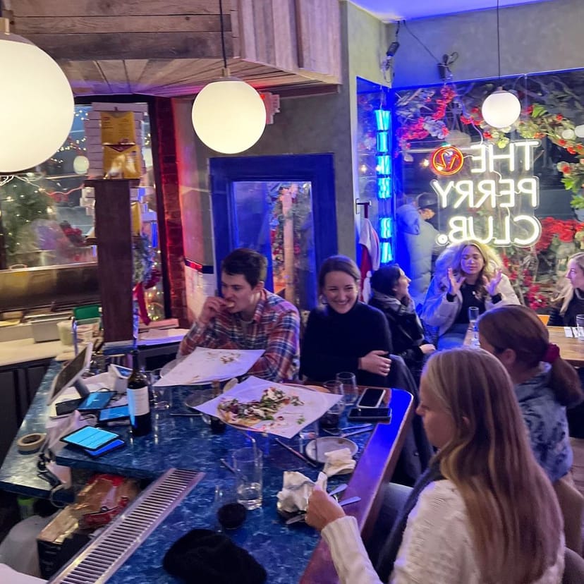 Lively Il Grottino Room bar with neon lights for casual networking events.