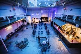 Versatile rooftop event space at Terminal 5 with ambient lighting for gatherings.