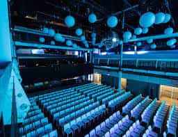 Modern event space at Terminal 5 with tiered seating for conferences and performances.