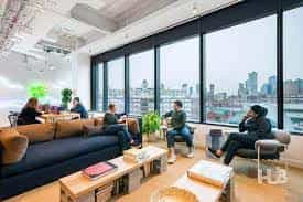 Modern rooftop terrace meeting space with city view, ideal for brainstorming and team-building.