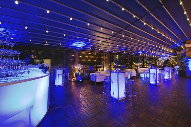 Midtown Terrace event space with modern lounge seating and illuminated bar for receptions.