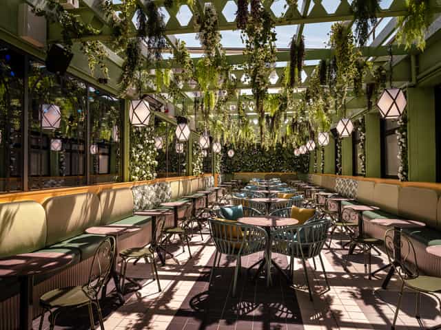 Elegant event space with lush greenery, ideal for intimate gatherings and networking.