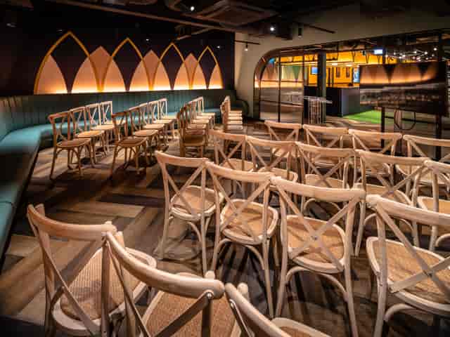 The Boathouse event space with stylish wooden chairs for presentations and workshops.