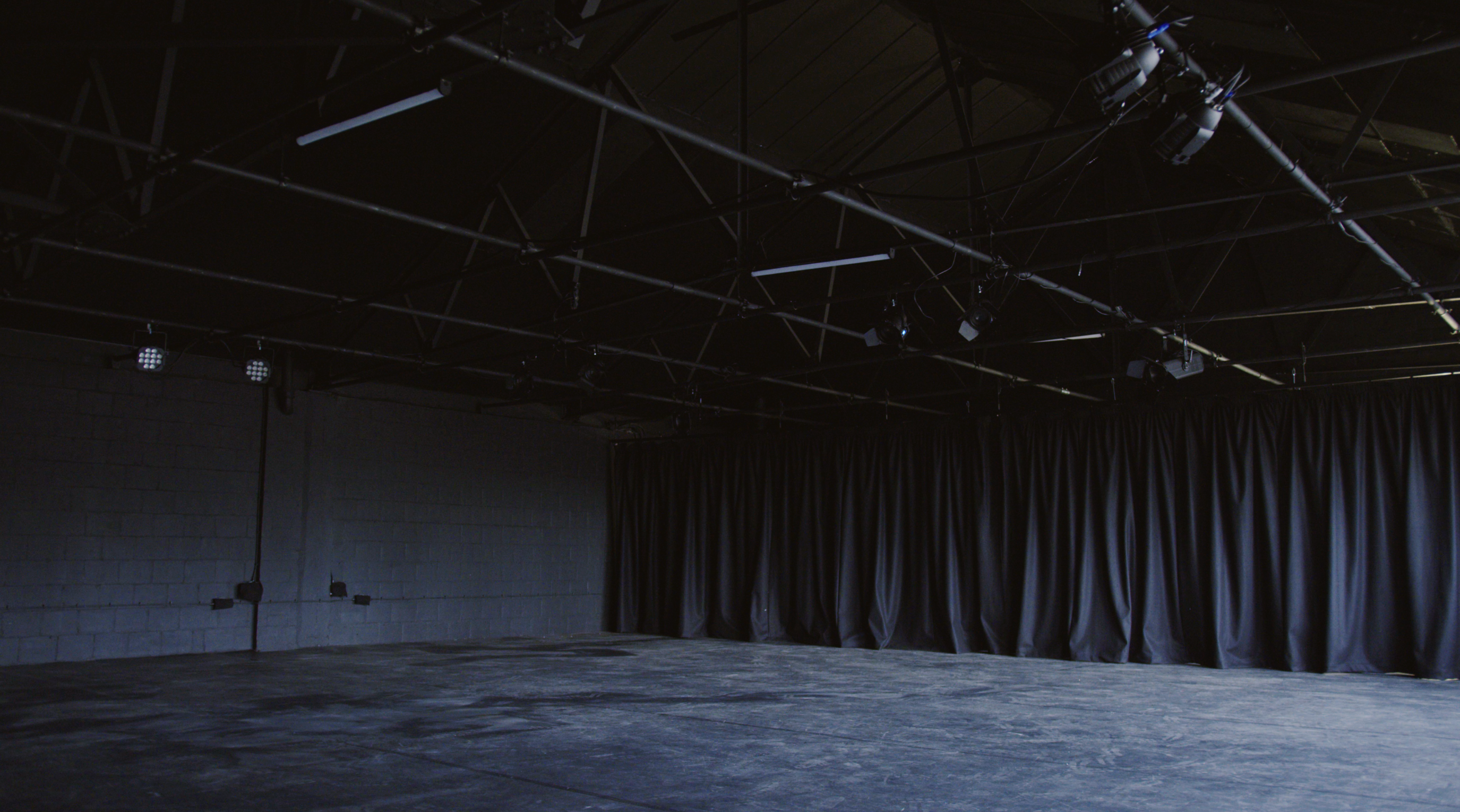 Versatile minimalist event space with high ceilings at Klatch Studio's Black Box. - Banner