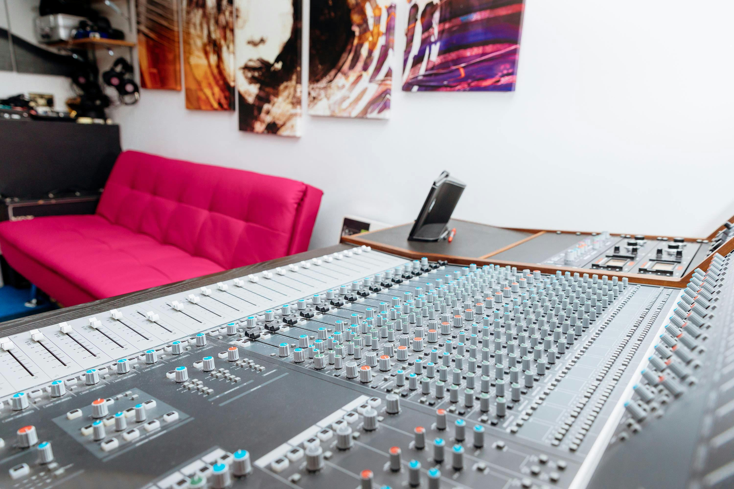 Modern recording studio with audio mixing console, ideal for creative workshops and events.