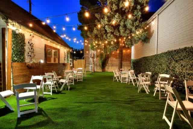 Charming outdoor event space with string lights for intimate gatherings in Queens.