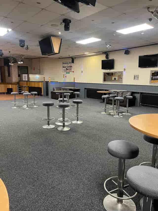 Versatile event space with high-top tables for corporate meetings and social gatherings.