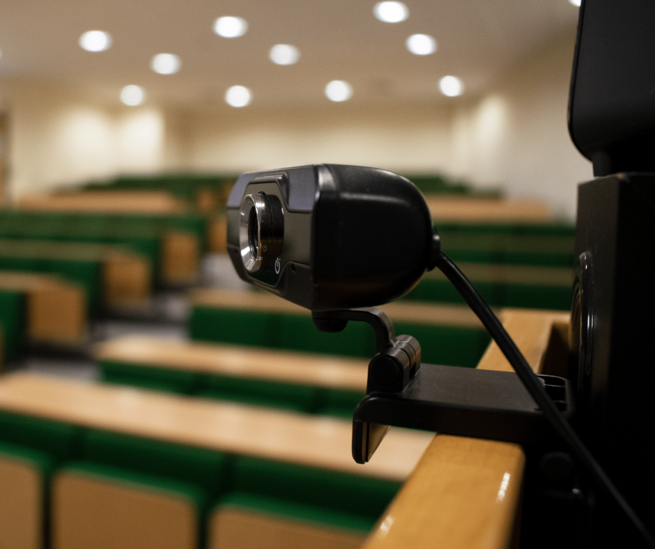 BCOM Lecture Theatre with green seating, ideal for hybrid events and presentations. - Banner