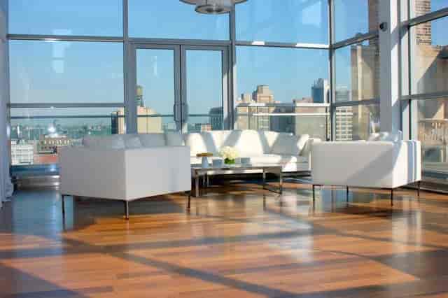 Modern penthouse event space with panoramic city views, ideal for meetings and networking.