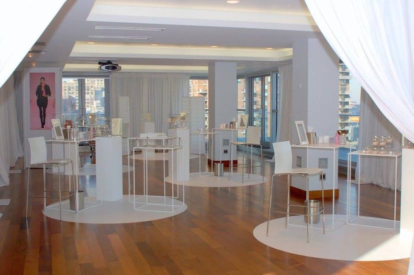 Modern penthouse event space with elegant white furniture for networking events.