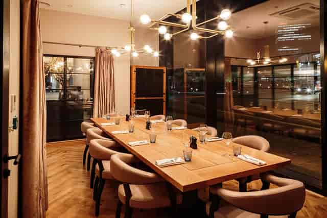 Private dining room with elegant table settings at Embankment Kitchen, ideal for events.