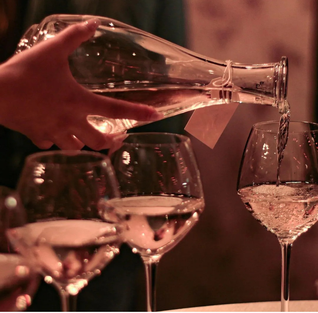 Elegant wine pouring in The New Roxy's private dining room for networking events.