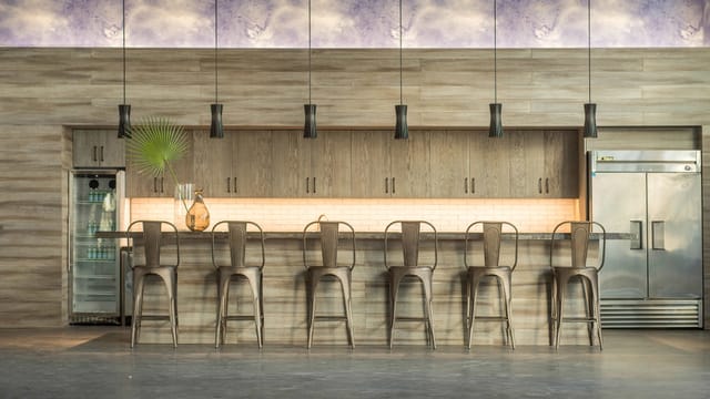 Modern bar area with high stools, ideal for cocktail receptions and social gatherings.
