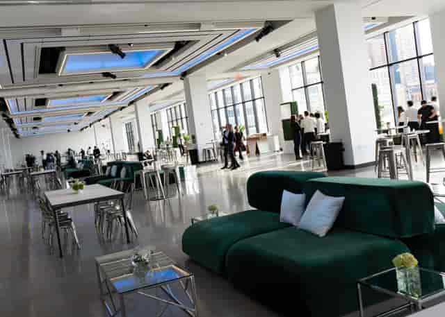 Modern event venue with large windows, ideal for networking and social gatherings.