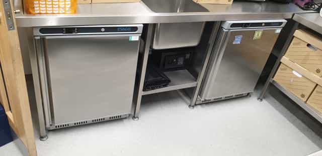 Eden Cafe Kitchen Hire: sleek stainless steel kitchen with under-counter fridges for events.