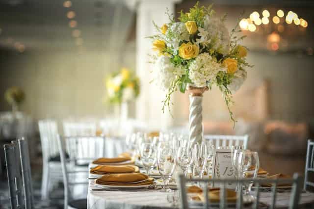 Elegant banquet table with floral centerpiece at Grand Oaks Country Club event.
