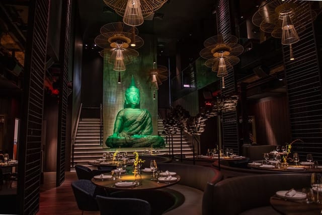 Buddha-Bar Restaurant NYC with green Buddha statue, ideal for upscale events and gatherings.