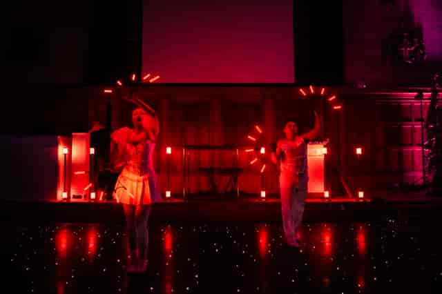 Dynamic performance in The Great Hall with vibrant red lighting for events and celebrations.