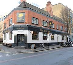 Charming pub exterior with outdoor seating, perfect for networking events and casual gatherings.