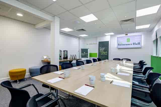 Jubilee Room in Insurance Hall, modern meeting space with long table and refreshments.