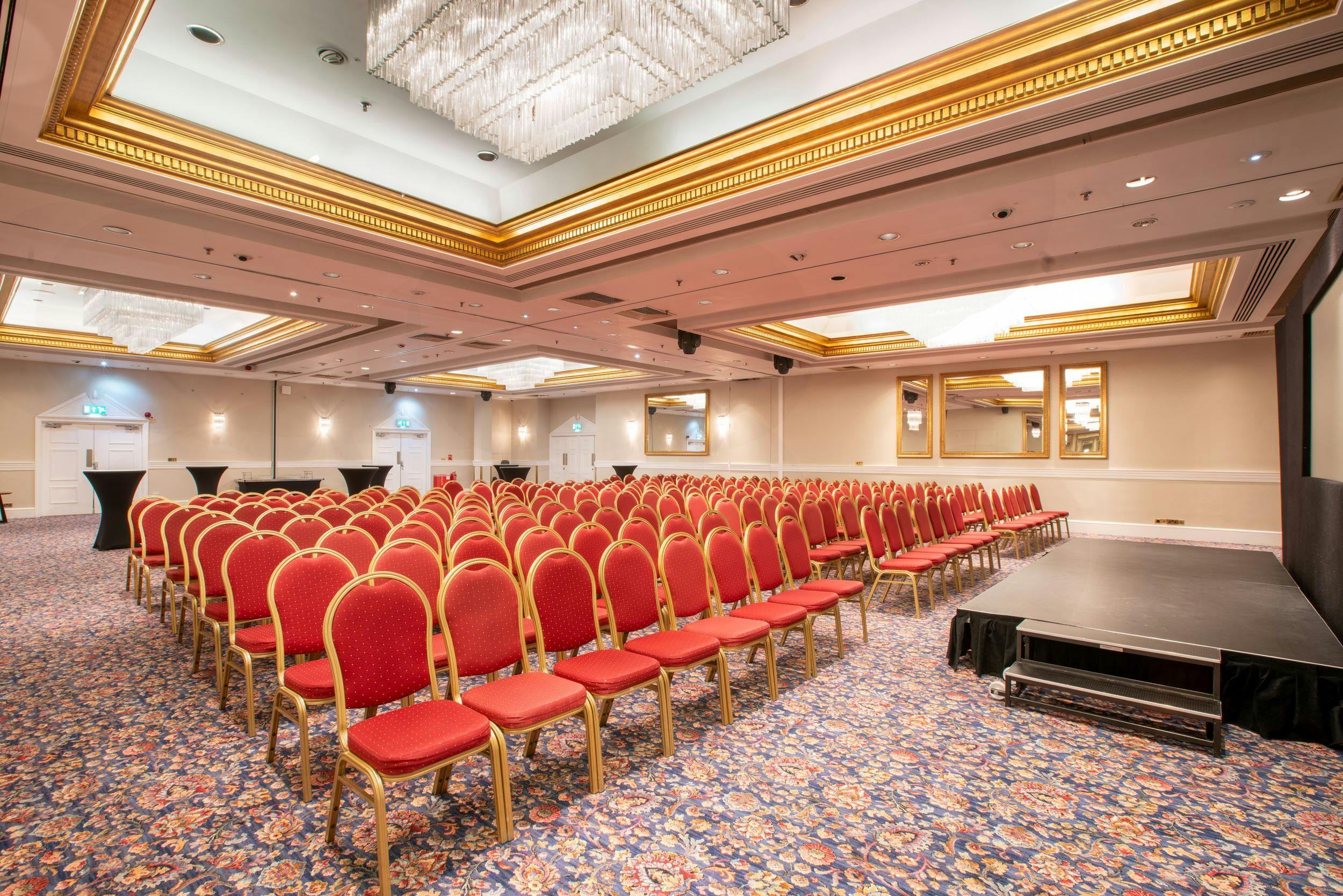 Cromwell Suite event space with red chairs, ideal for conferences in London.