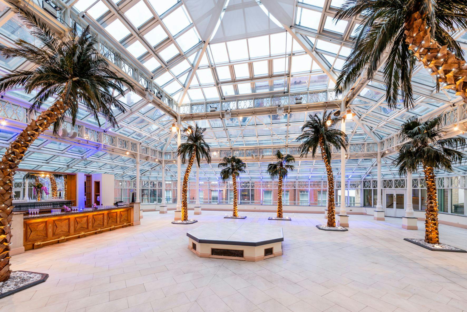 Spacious Conservatory venue with glass ceiling, ideal for weddings and corporate events.