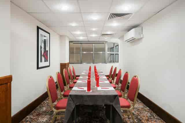 Elegant Prince Boardroom with red accents, perfect for corporate meetings and private dinners.