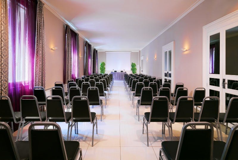 Meeting space at Sheraton Diana Majestic, Milan with black chairs for conferences.
