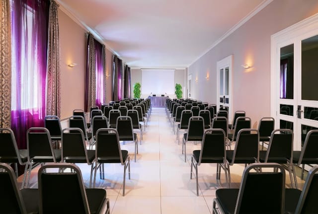 Meeting space at Sheraton Diana Majestic, Milan with black chairs for conferences.