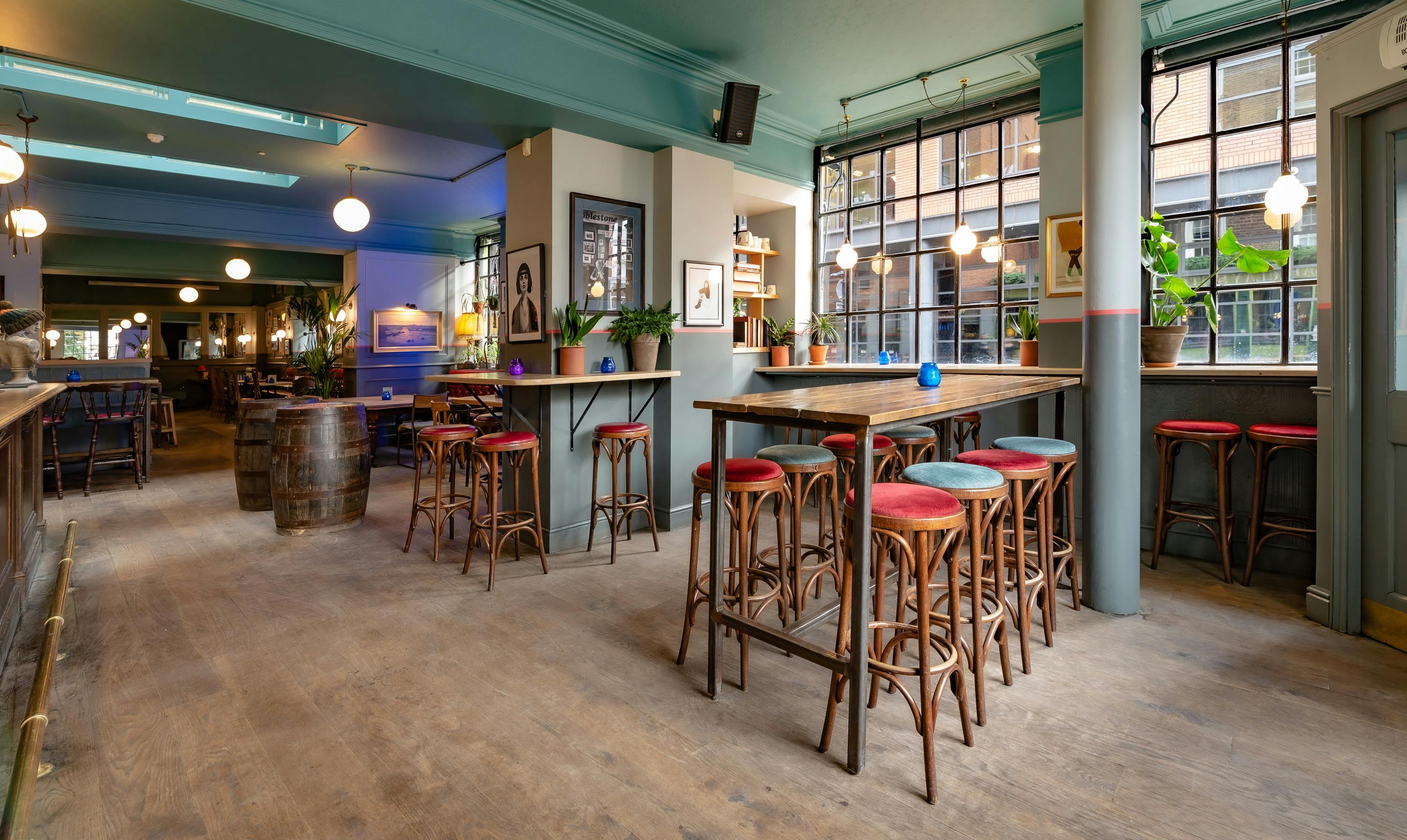 Stylish dining room with high-top tables for casual meetings and networking events.