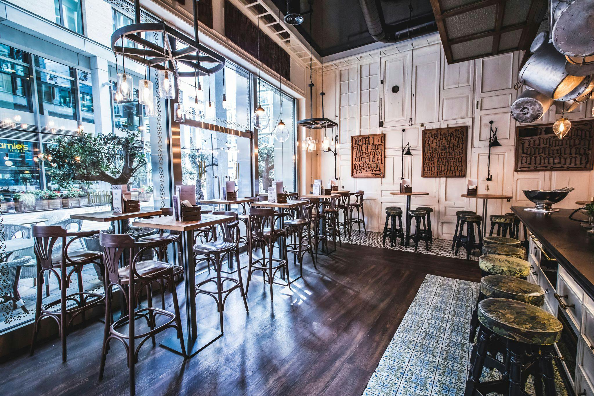 Bar area in Ibérica Victoria with high tables, perfect for social events and networking.