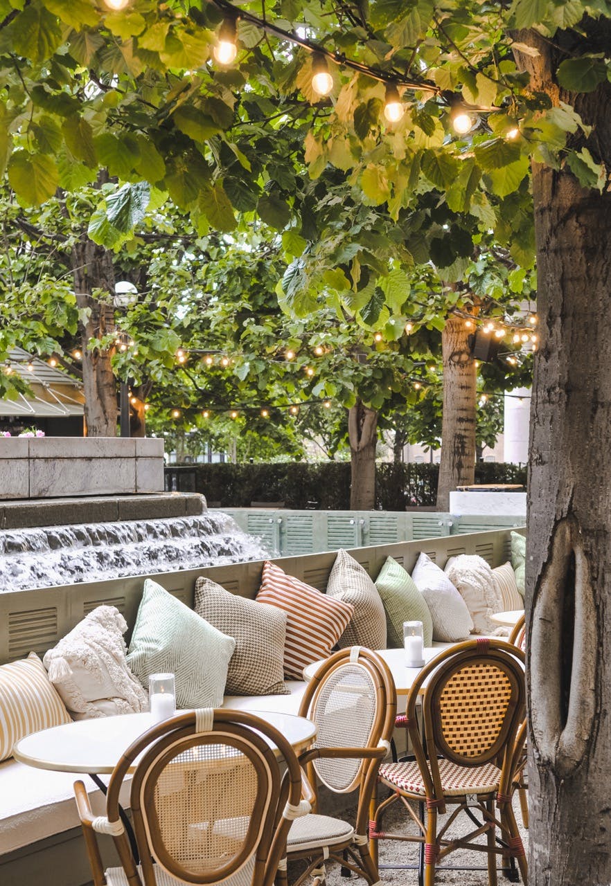 Serene outdoor event space with cozy seating and lush greenery for gatherings.