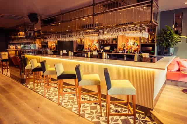 Stylish cocktail bar with ample seating, perfect for networking events and receptions.