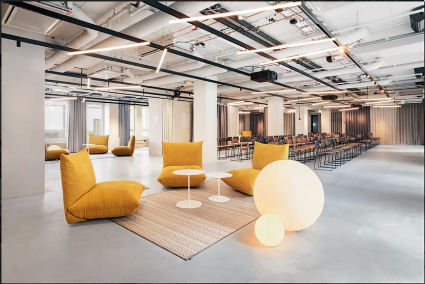 Modern event space at Blomsterkiosken, featuring yellow bean bags for networking.