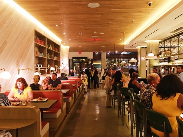 Vibrant restaurant with cozy booths, ideal for casual meetings and networking events.