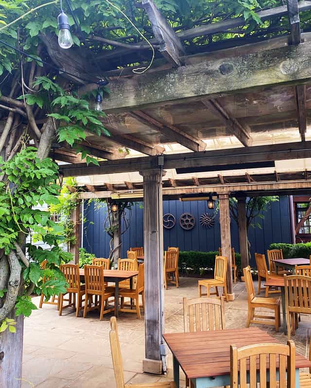 Piedmont Room outdoor event space with rustic pergola, ideal for gatherings and meetings.