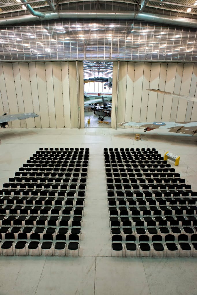 Conservation Hall at IWM Duxford with aircraft backdrop for corporate events.