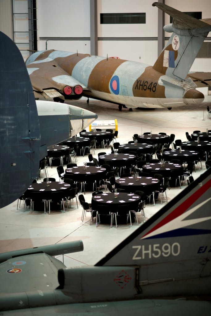 Conservation Hall at IWM Duxford: elegant event space with vintage aircraft backdrop.