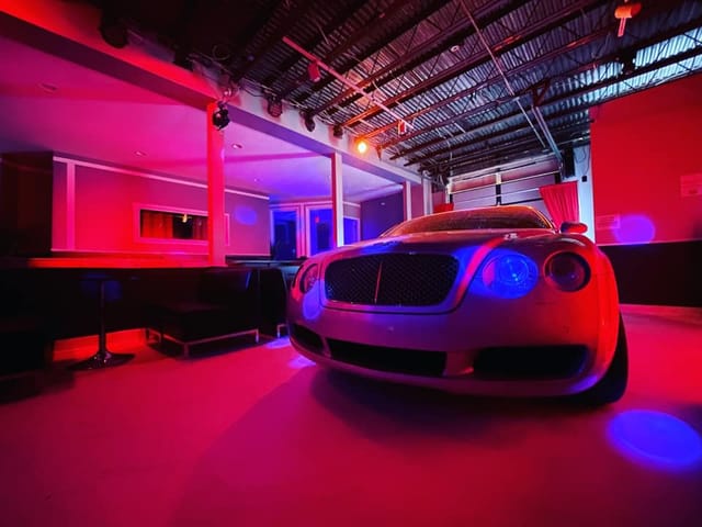 Luxury car in vibrant event space at Studio Stage, perfect for high-end parties and gatherings.
