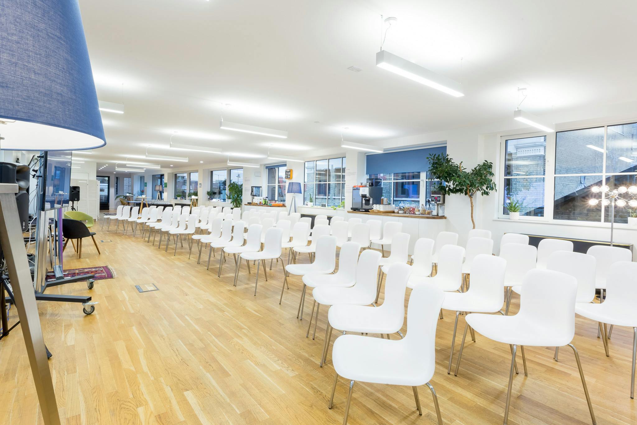 Rooftop Kitchen event space with modern white chairs, ideal for workshops and networking.