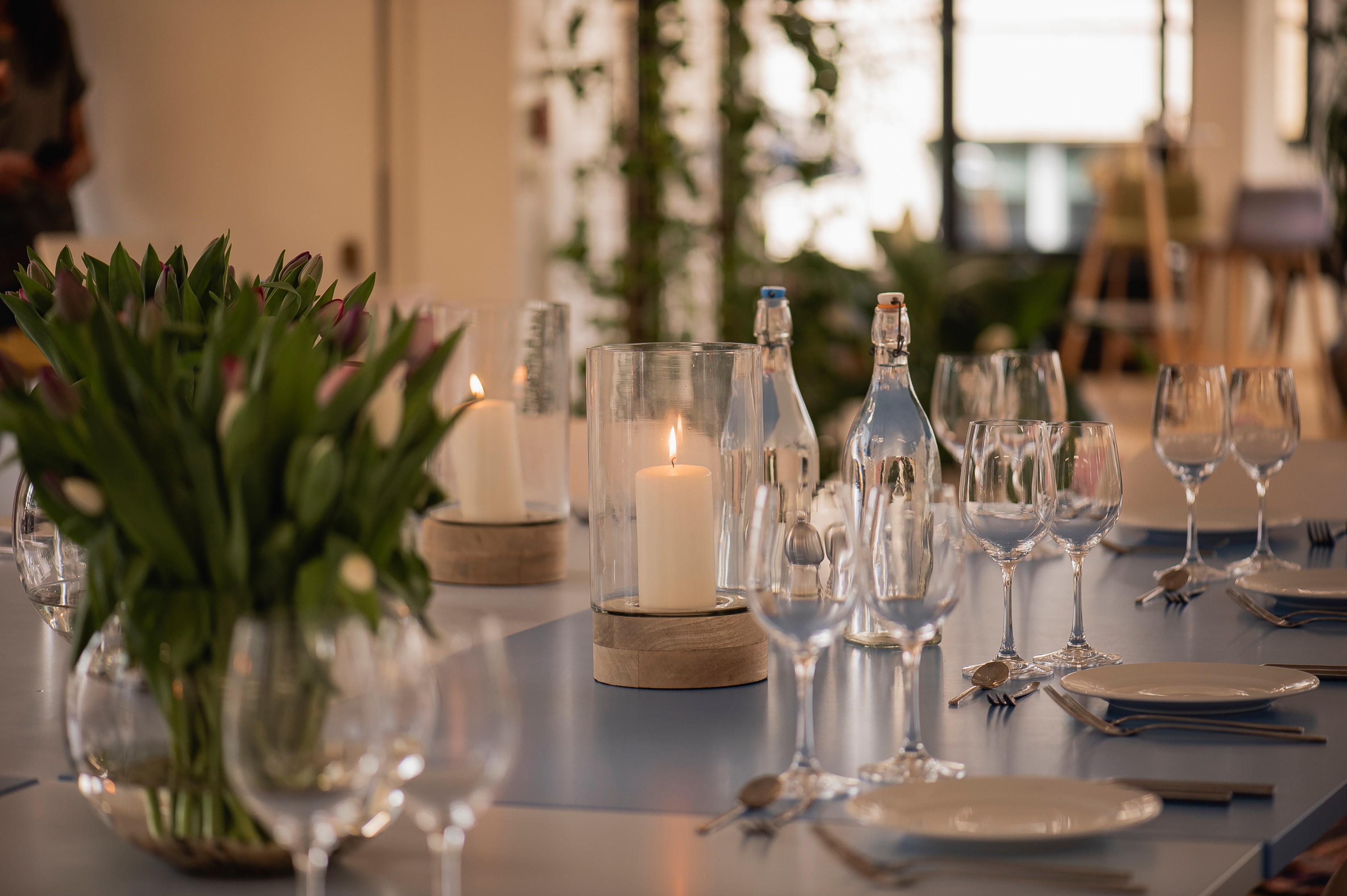 Elegant dining table with tulips at Rooftop Kitchen, perfect for sophisticated events. - Banner