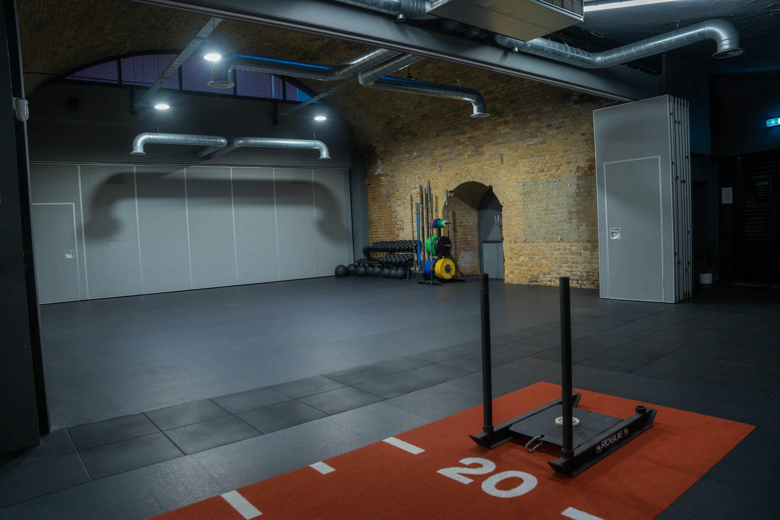 Versatile fitness event space with natural light at CrossFit Putney, ideal for workshops.