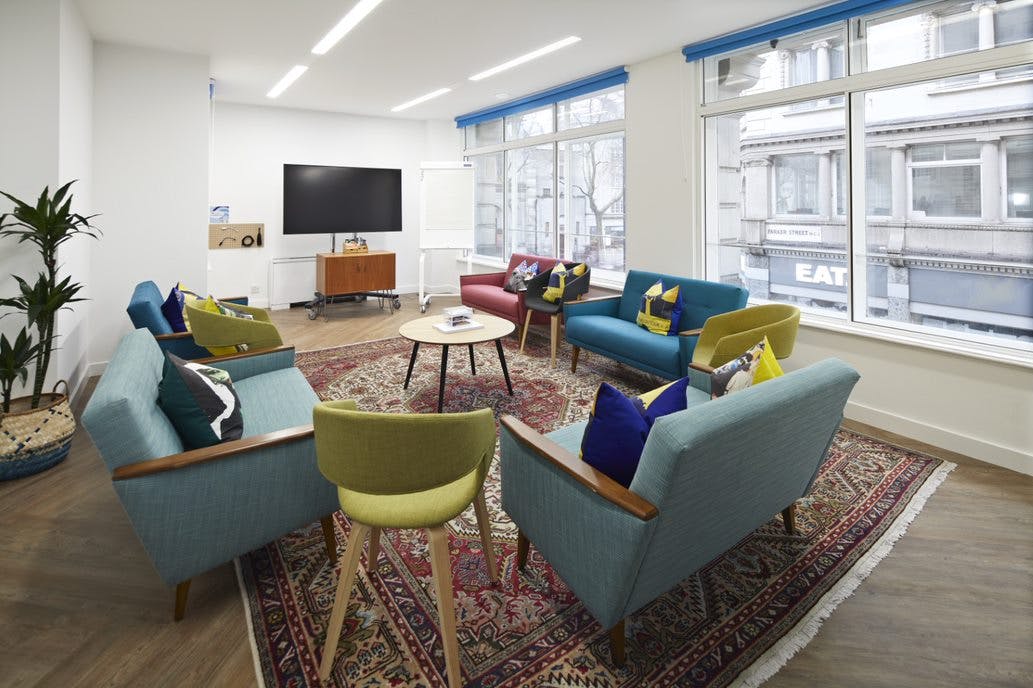 Modern meeting space with vibrant seating and natural light for creative collaboration.