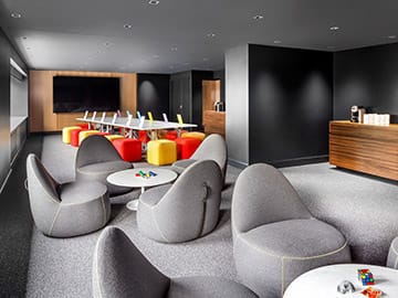 Modern meeting space at LG Tech, featuring a sleek table and vibrant seating for events.