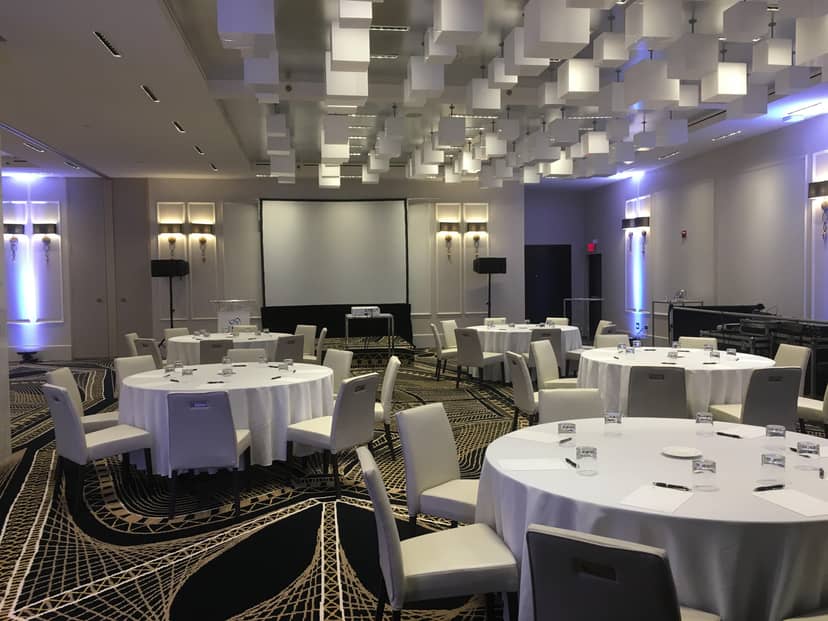 North Room at Le Mount Stephen: modern event space with round tables for corporate meetings.