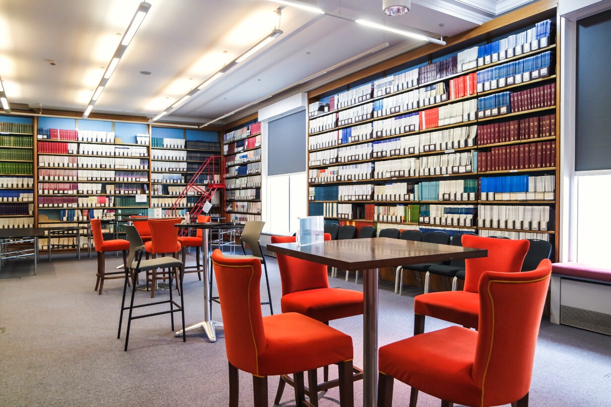Wheatley Room meeting space with vibrant orange chairs, ideal for workshops and brainstorming. - Banner