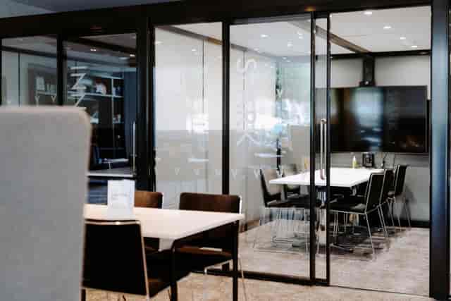 Modern meeting room at The Village Hotel Watford with glass walls for collaboration.